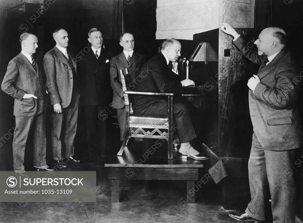 New York, New York:  April 8, 1927 AT& T president Walter Gifford, sitting at Bell Labs in NY,  talking as well as seeing Secretary of Commerce Herbert Hoover in Washington, D.C. in the first public demonstration of television. With Gifford are L-R, Bell Lab members, E. P. Clifford,  Vice President; H.D. Arnold. Director of Research, E.B. Craft, Executive Vice President, F.B. Jewett, President of At&T, and Dr. Herbert Ives, technical staff member.