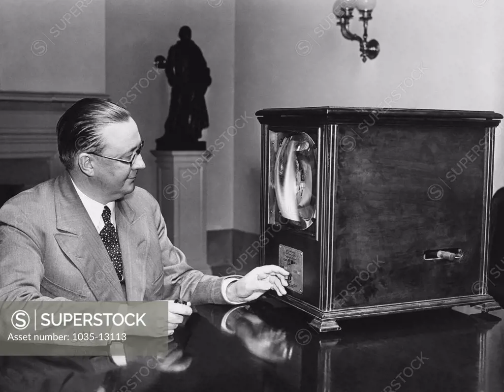 Washington, D.C.:  July 8, 1931 George Hastings, Secretary to President Herbert Hoover, examines a television receiver in his office at the White House.