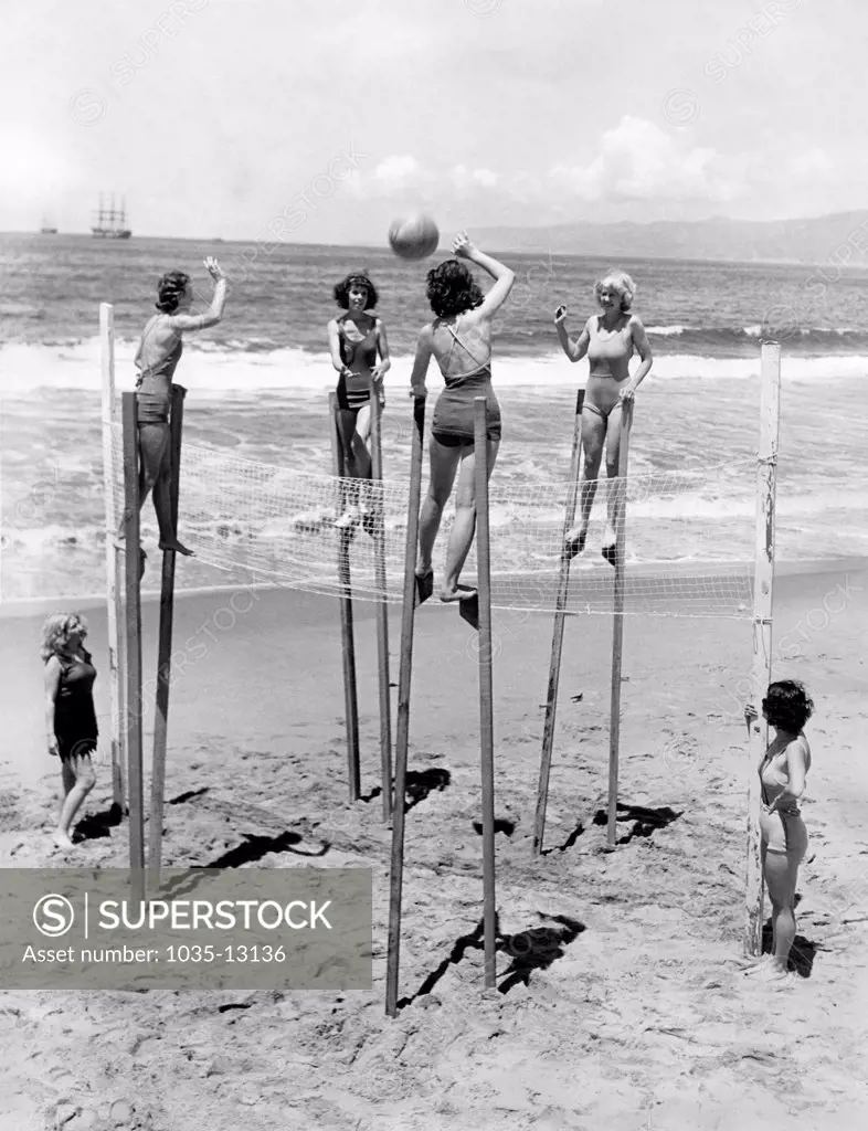 Venice, California:  June 6, 1934 Four young women elevate their game of volleyball by playing it on stilts.