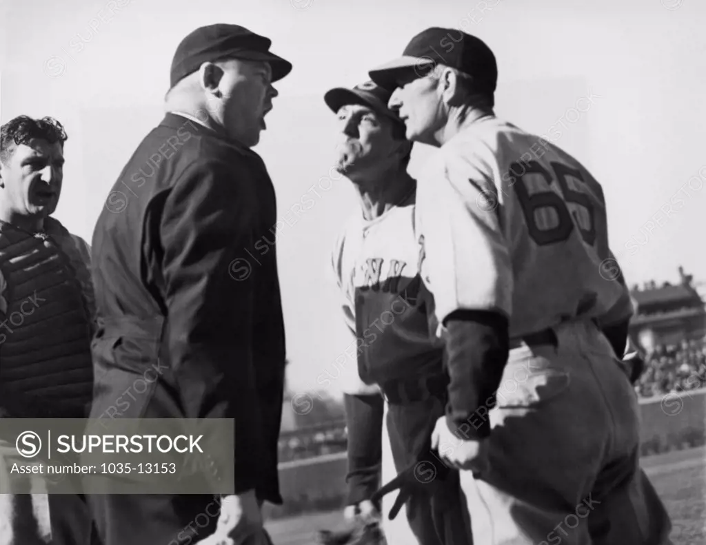 Chicago, Illinois:  April 30, 1938 At Wrigley Field, Umpire Magerkurth called it a ball, and Cincinnati Reds pitcher Joe Cascarella (center) says it was a strike with Reds manager Bill McKechnie joining in with Joe.