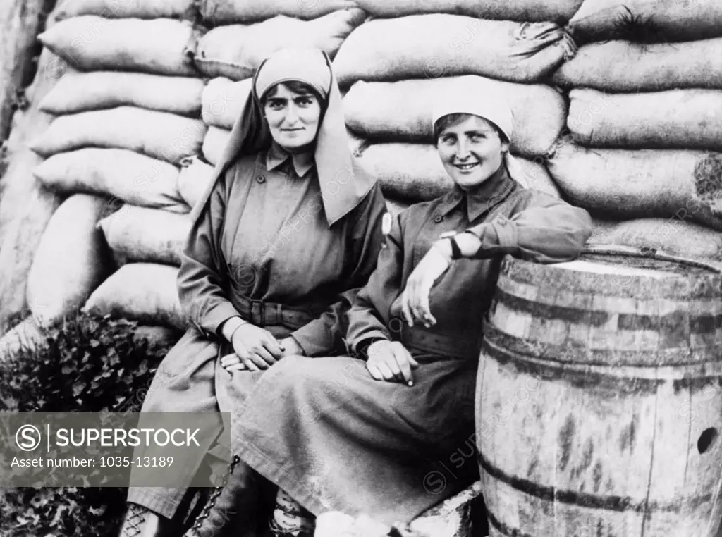 Belgium:  November 16, 1917 Two British women who are serving directly behind British trenches and taking care of the wounded soldiers.
