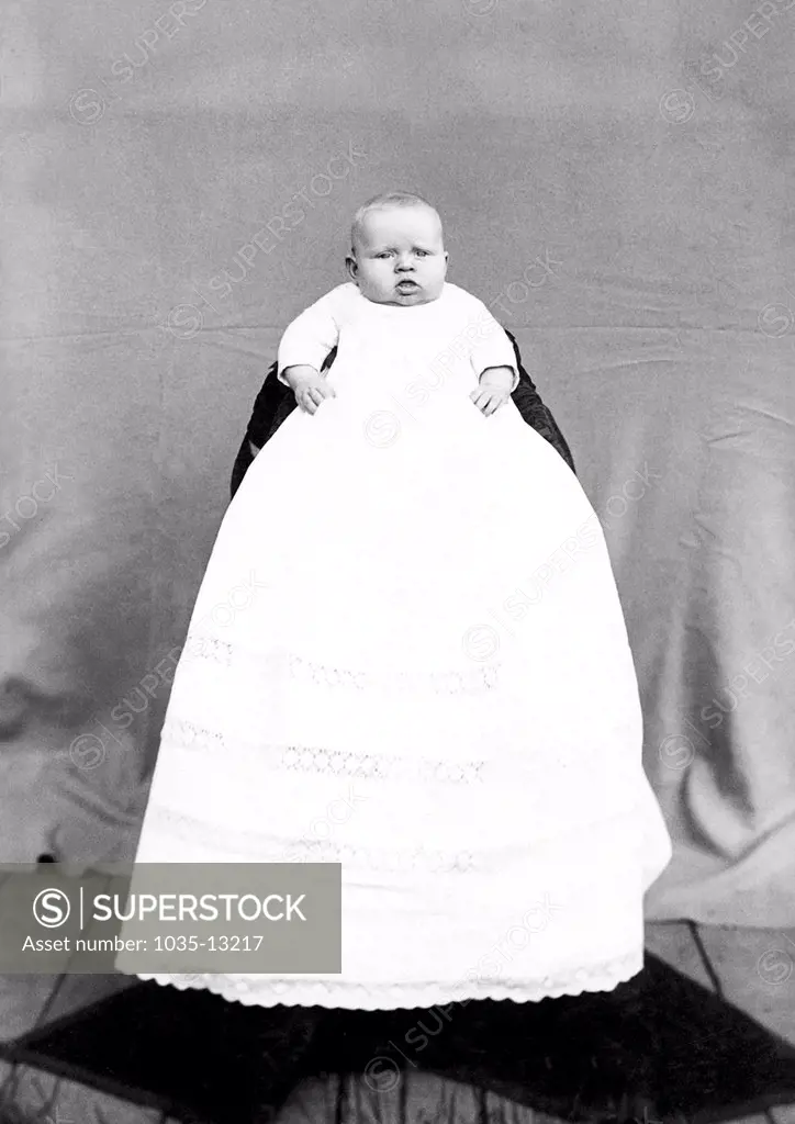 San Francisco, California:  c. 1885 A cabinet card portrait of a baby in a very long dress.