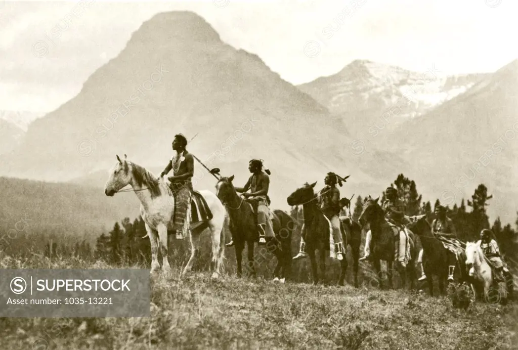 United States:  1918. A photogravure by Roland Reed  of Piegan Native Americans on horseback titled 'The Pass Finders'