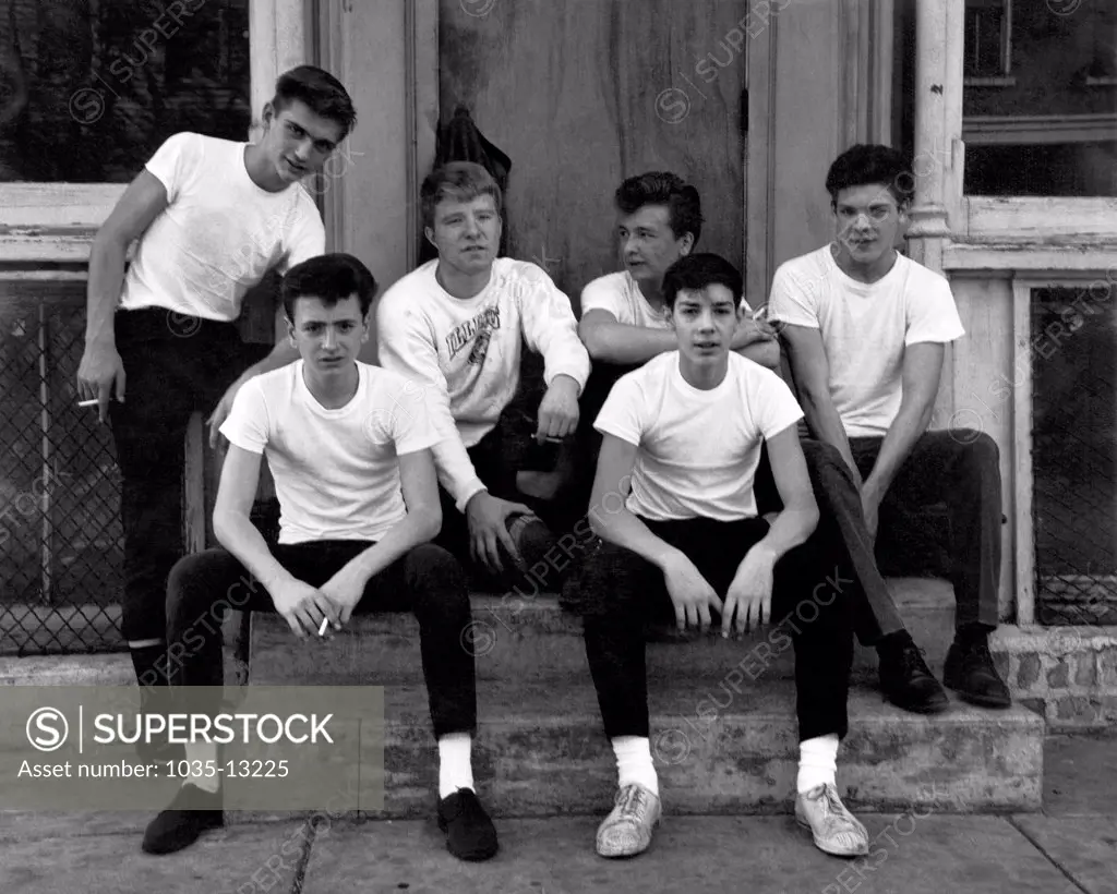 Chicago, Illinois:  c. 1953 A group of urban teenage boys siiting on a step.