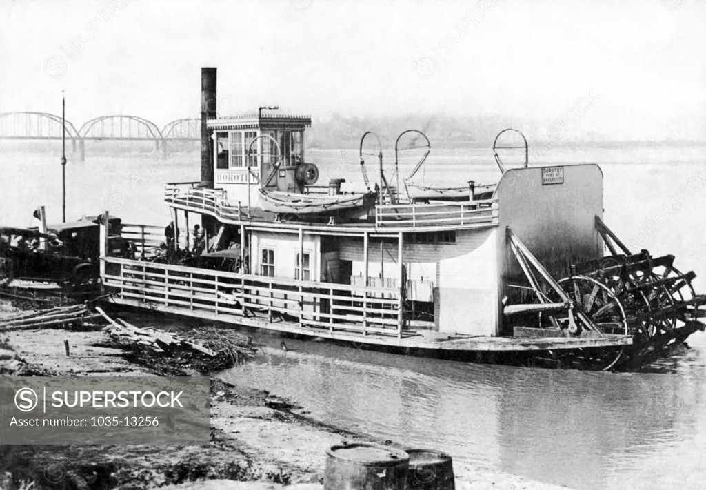 Kansas City, Missouri:  c. 1915 A paddlewheel steamboat ferry loading up cars to go across the Missouri River. The ferry's name is 'Dorothy', and is based in the Port Of Kansas City.