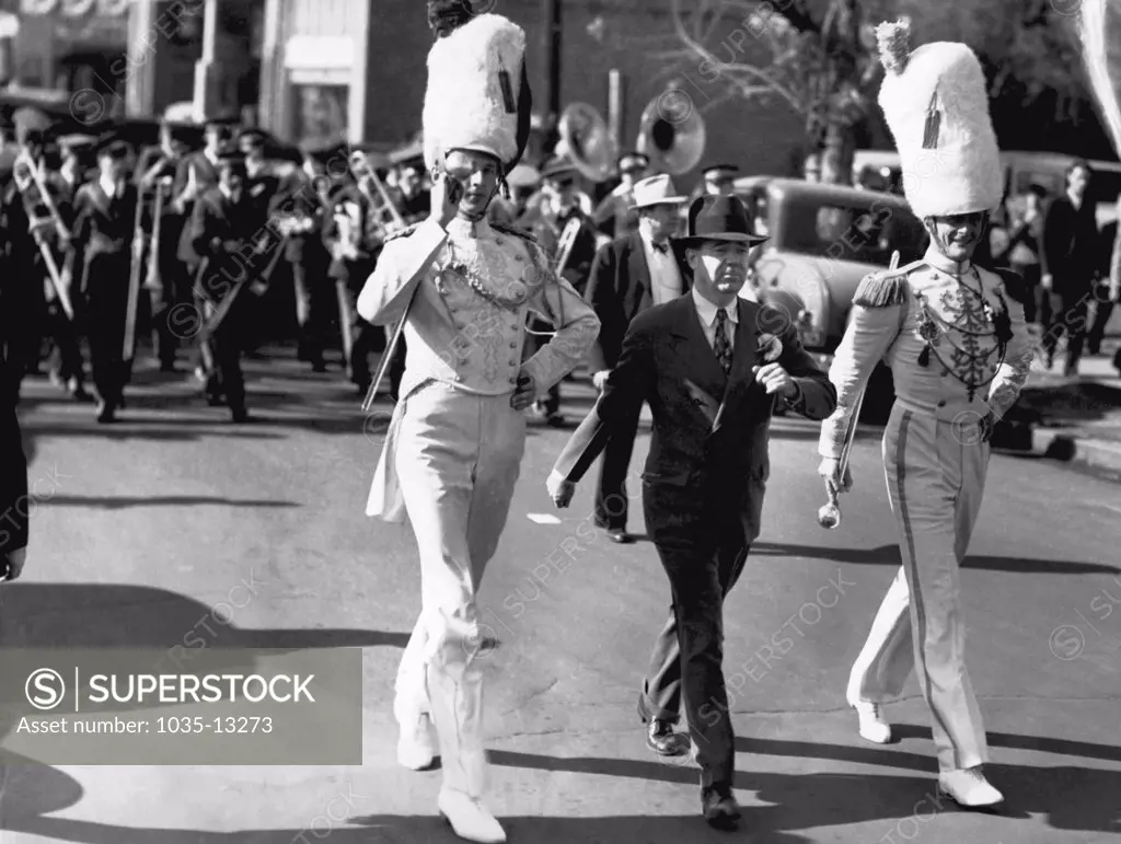 Jackson, MIssissippi:  November 18, 1934 Louisiana Senator Huey Long joins the LSU drum majors in the parade at Jackson for the annual LSU-Mississippi game.