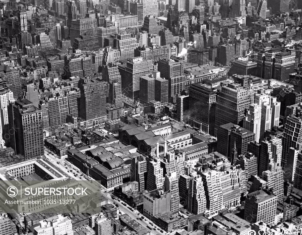 New York, New York:  c. 1924 Aerial view of the Pennsylvania Railroad Station district. Penn Station is at center with the square Post Office Building to the left.