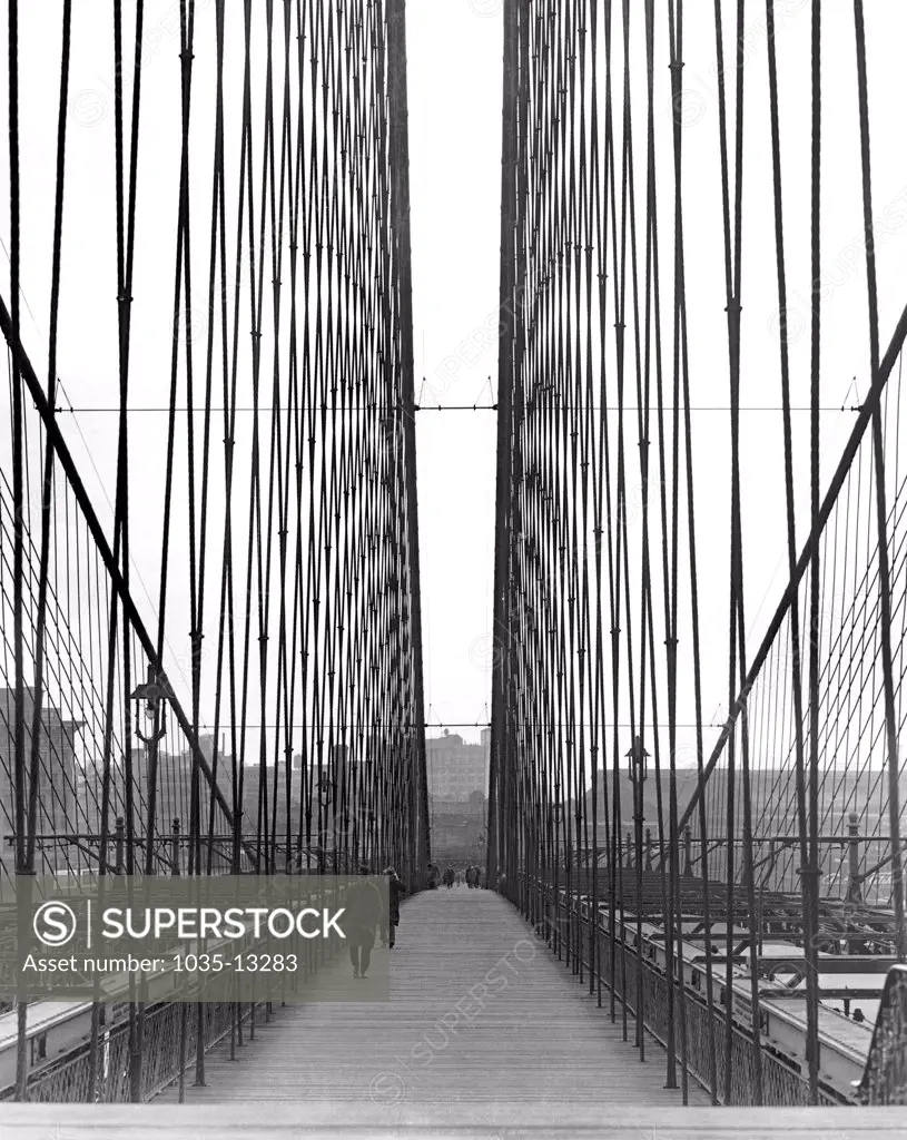 New York, New York:  c. 1930 The first of the great suspension bridges, the Brooklyn Bridge was begun in 1870 and completed in 1883 at a cost of $25,000,000, an enormous sum at that time.