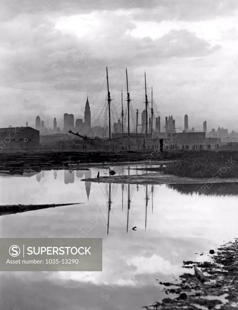 New York, New York:  July 7, 1935 Looking at the New York City skyline from Long Island through the rigging of a three masted schooner. The Chrysler Buillding is the tallest at left.