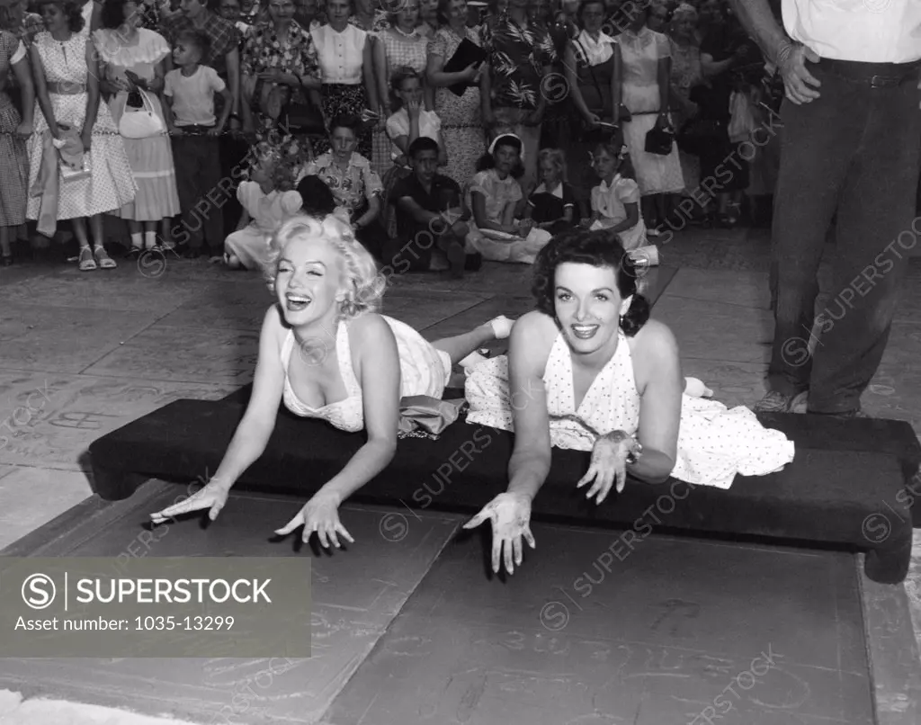 Hollywood, California:  June 26, 1953 Actresses Marilyn Monroe L) and Jane Russell put their handprints in wet cement at Grauman's Chinese Theater to promote their latest film, 'Gentlemen Prefer Blondes'.
