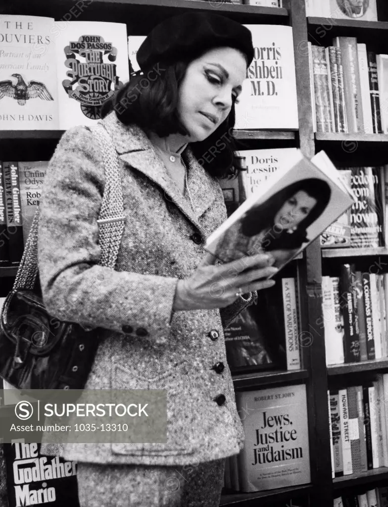New York, New York:  1969 Author Jacqueline Susann  in a Times Square bookstore looking at her latest book, 'The Love Machine'.