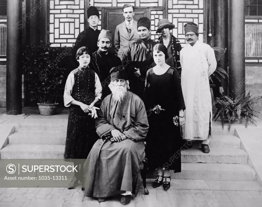 Peking, China:  June 24, 1924 HIndu philosopher, poet and lecturer Rabindranath Tagore with a group of the Chinese Lecture Association. On the left is an exponent of modern rights for Chinese women and on the right is the American tutoress to the Manchu Empress. Behind him are members of his Indian staff.