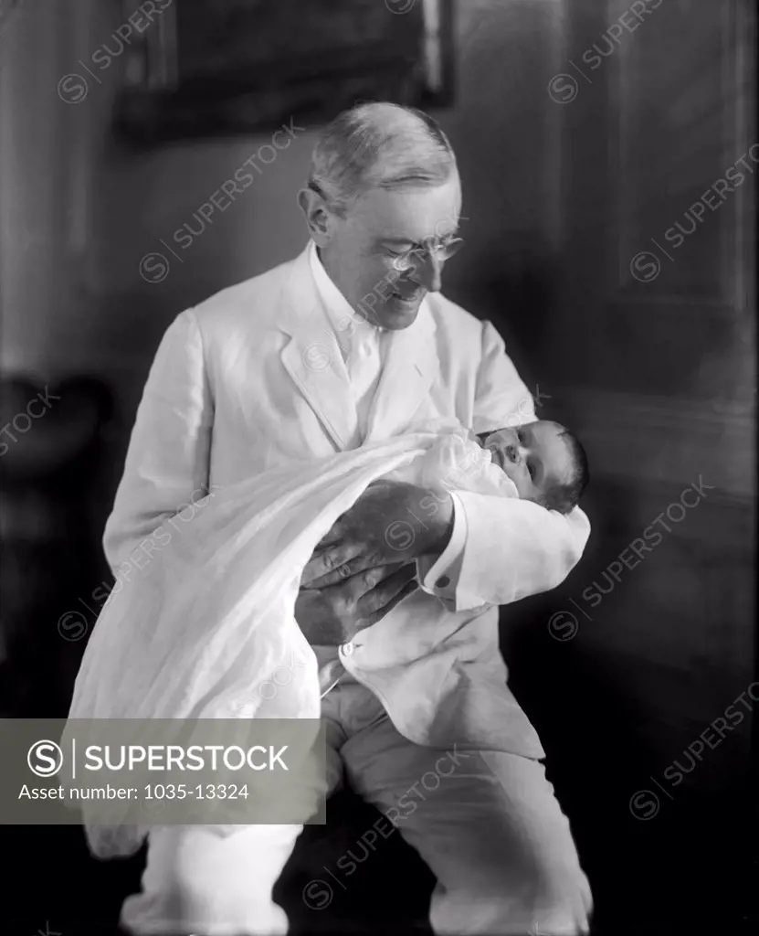 Washington, D.C.  1915 President Woodrow Wilson holding his granddaughter Ellen Wilson McAdoo.