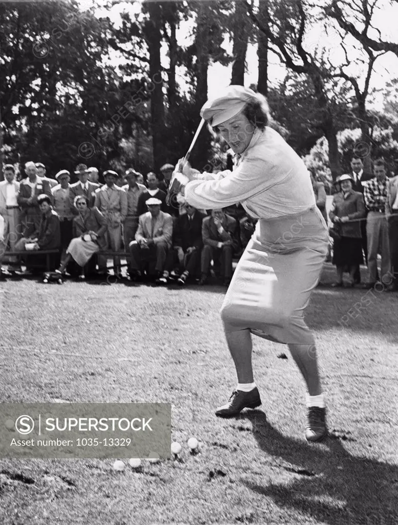 Pebble Beach, California:  c. 1951 Babe Didrikson gives a golf demonstration on teeing off in a tight skirt at the Weathervane golf tournament.