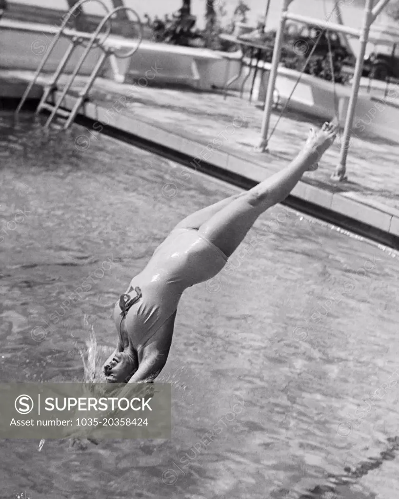 Miami Beach, Florida:  1936 A young woman does a graceful back dive into the Flamingo Pools.