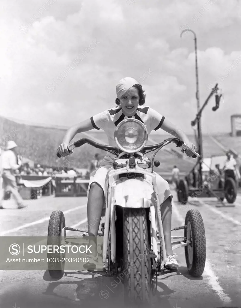 Hollywood, California:  1932. Susan Fleming takes a ride on a three wheeler through the set of "Million Dollar Legs" in Hollywood.