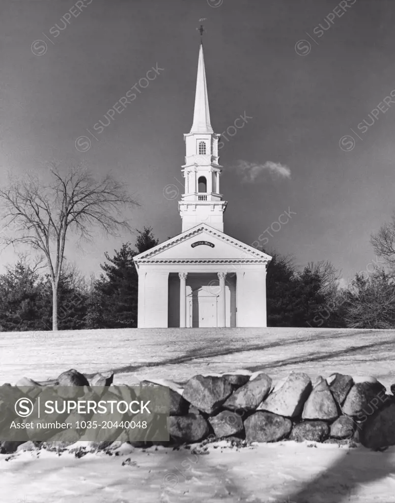 Sudbury, Massachusetts:  c. 1958 A front view of a classic New England church in the wintertime. It was built by Henry Ford.