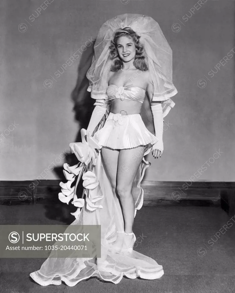 United States:  June, 1947 A model is the bride of the future wearing spun glass pants and bra, glass net veil, and a brief skirt of accordian-pleated glass satin.