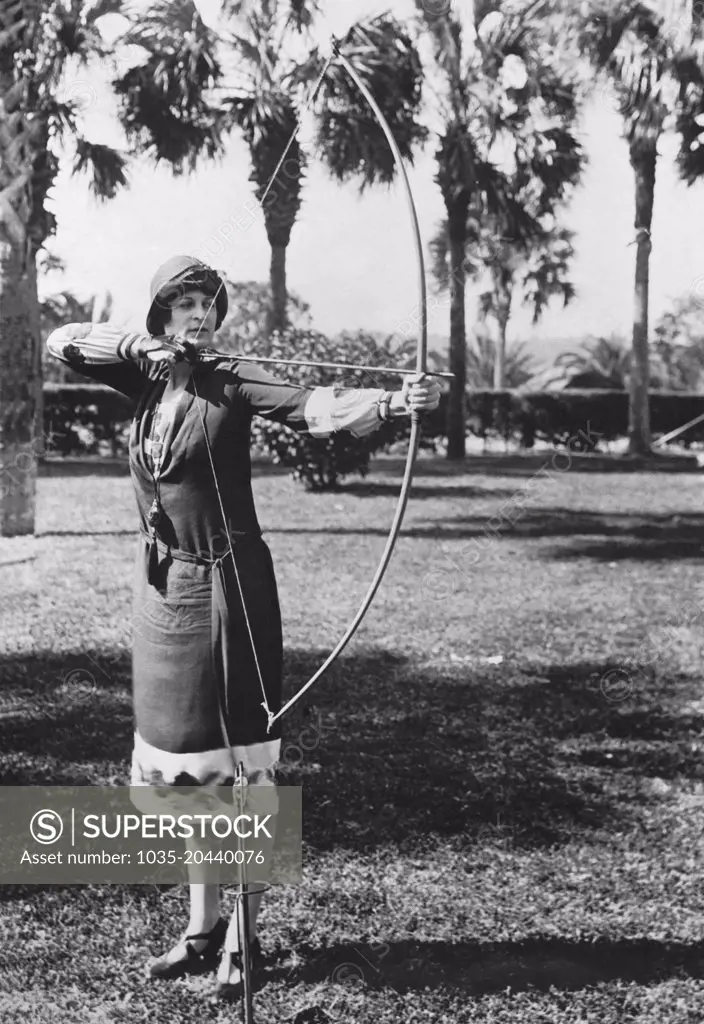 Ormond Beach, Florida:  February 9, 1926 Elizabeth Detwiller gives a demonstration of her skills with the longbow at the Hotel Ormond. She is the only woman member of the famous Swiss archery club, "Club De L'Arc" of Lausanne, Switzerland.