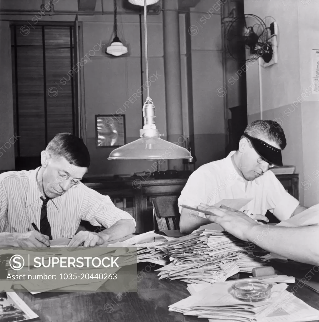 New York, New York:  September, 1942 Copyreaders at the foreign desk in the newsroom of the New York Times newspaper.