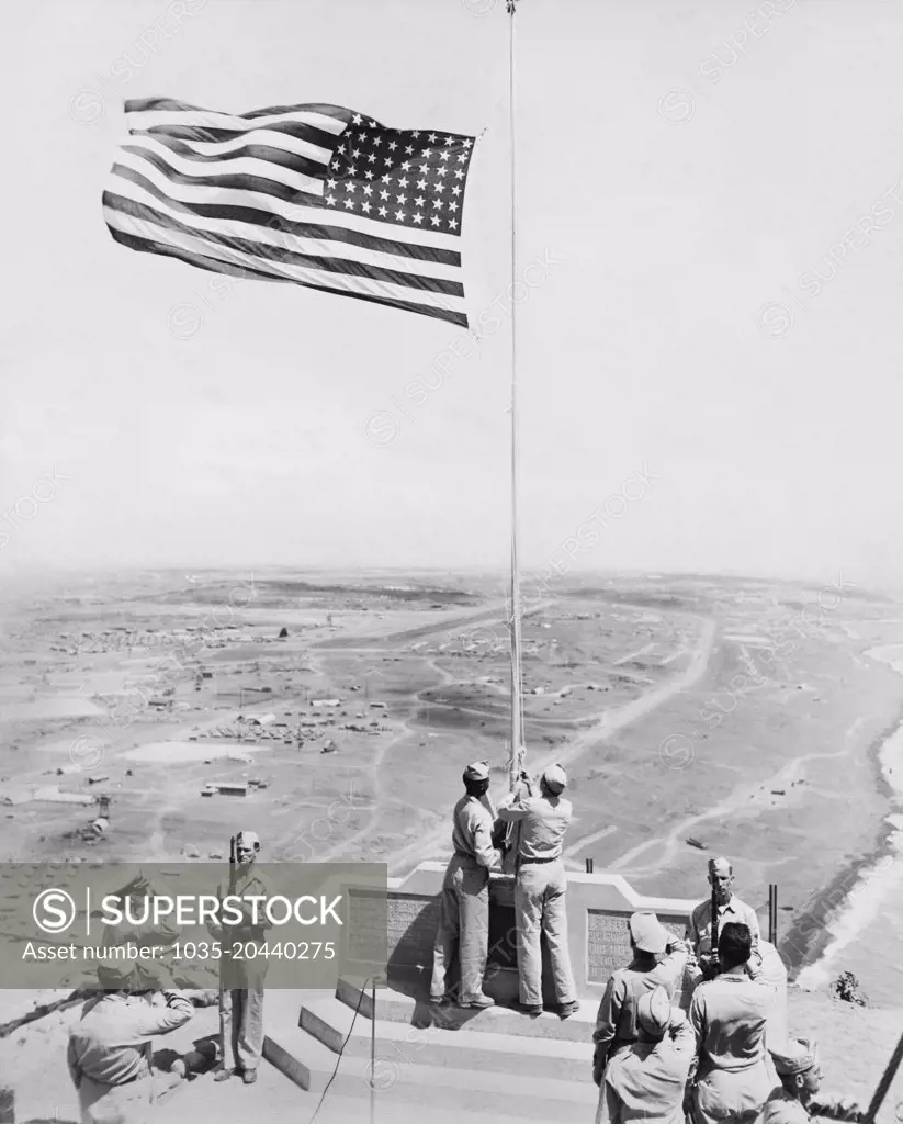 Iwo Jima, Japan:  c. 1955 An American flag ceremony at the monument on Mt. Suribachi on Iwo Jima where Joe Rosenthal took his iconic photograph.