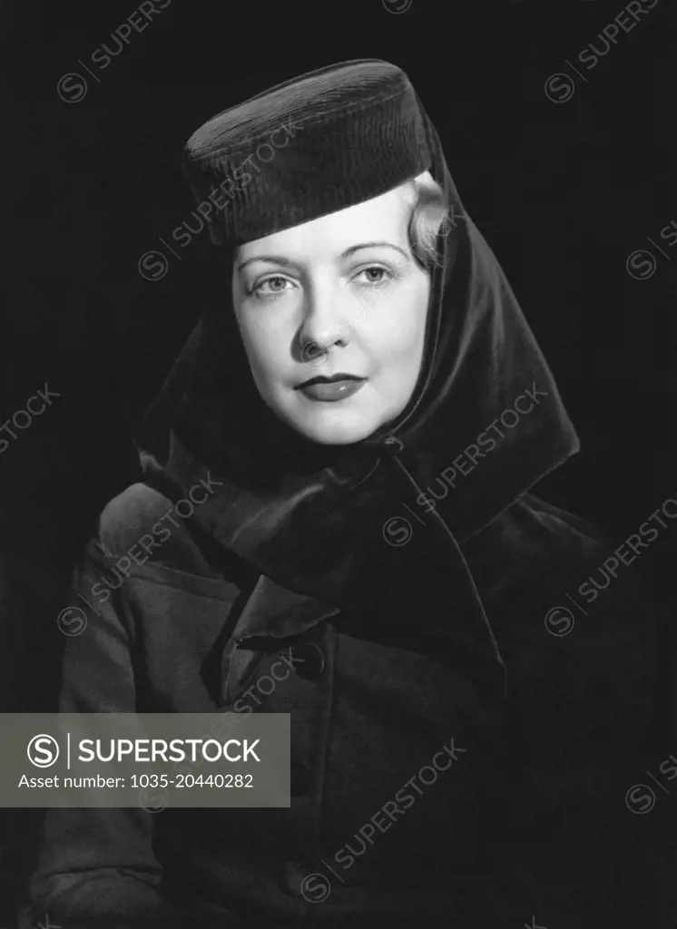 United States:  c.  1948 A fashion photo of a woman wearing a hat.