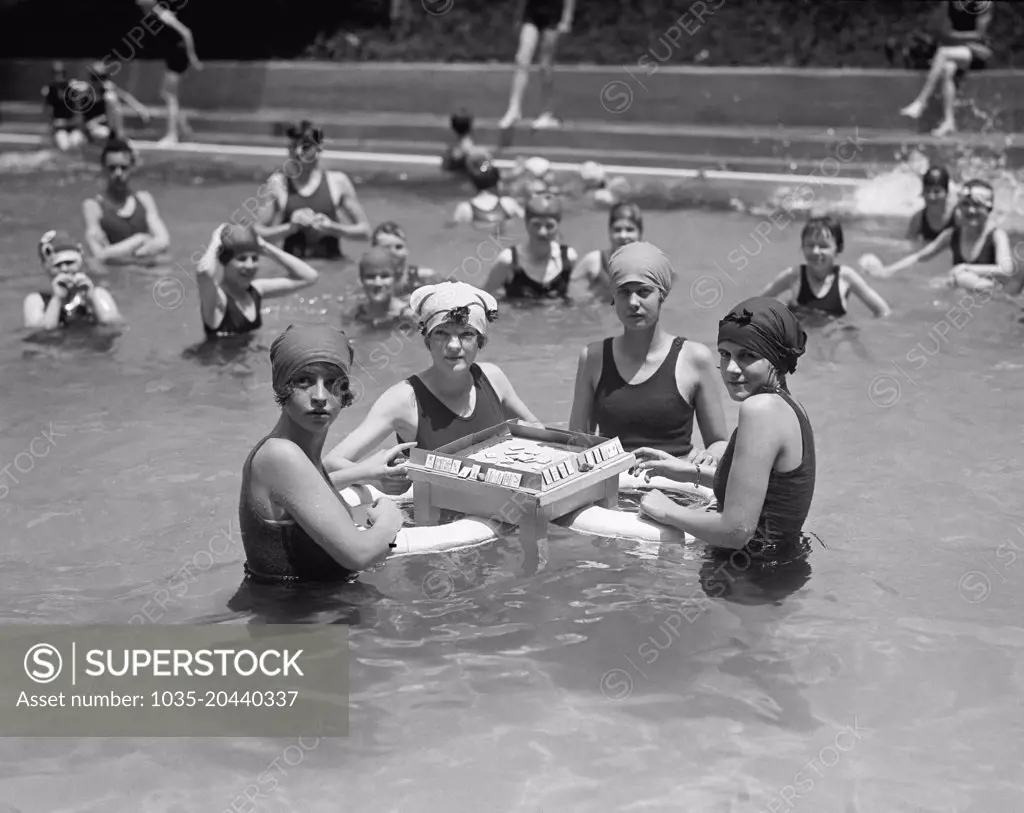 Washington, D.C.:  June 20, 1924 Four young women playing Mah-Jong on a floating table in a swimming pool.