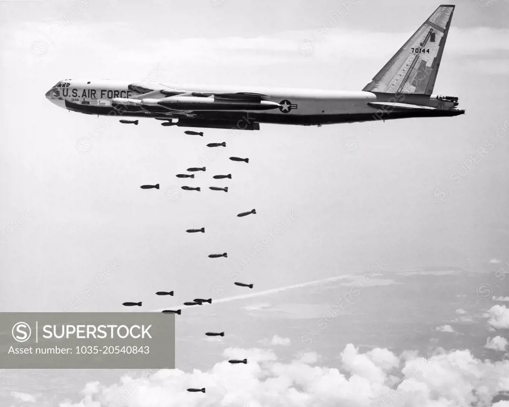 Vietnam:  October 30, 1965 A U.S. Air Force SAC B-52 Stratofortress releases a string of 750 pound bombs over a coastal Viet Cong target.