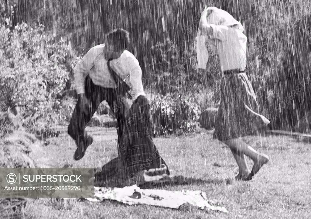 Hollywood, California:  September 9, 1965 This movie couple was having a delightful picnic lunch until the special effects man came along and blessed them with a torrential downpour.