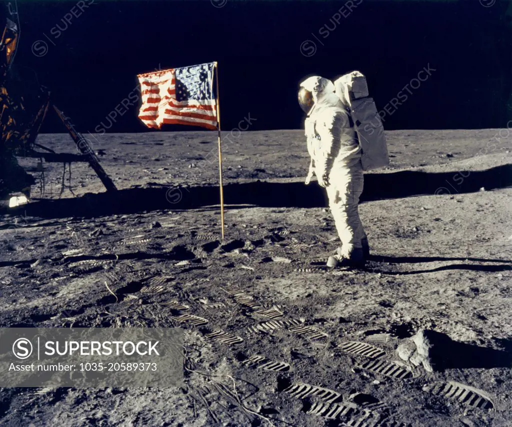 Moon:  July 20, 1969 Astronaut Edwin "Buzz" Aldrin, pilot of the lunar module, poses beside the United States flag during the Apollo 11 lunar landing. The Lunar Module "Eagle" is at the left. Commander Neil Armstrong took the photograph.