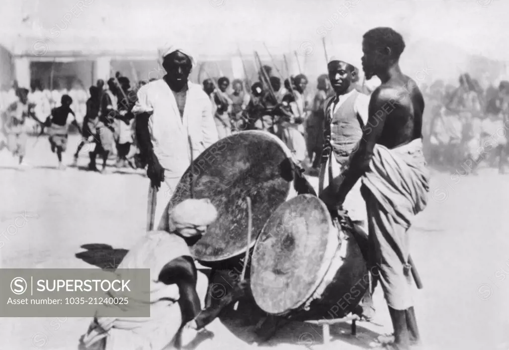 Ethiopia:  c. 1935 Natives in an Abyssinian village sound the war drums to gather troops for their Emperor Haile Selassie to fight the invading Italians.