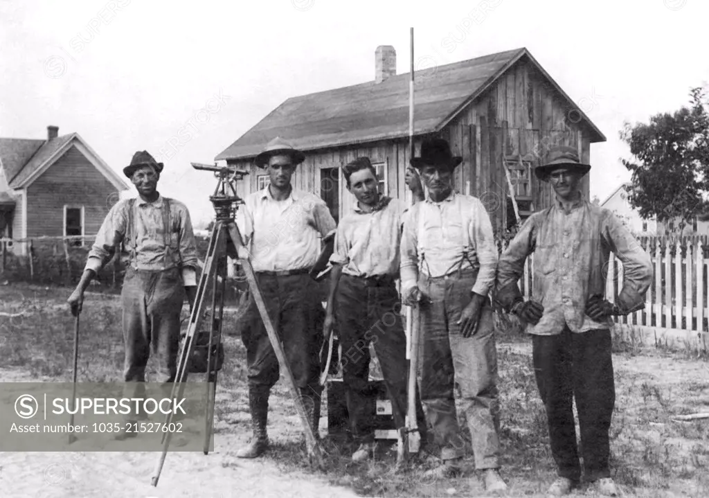 United States:  c. 1905 A team of surveyors pose for a portrait with their instruments of the trade.