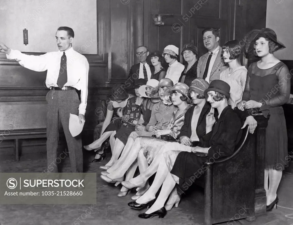 Chicago, Illinois: July 22, 1926. Photo shows a bench full of complainants listening to Assistant State's Attorney Robert M. Woodward make his charges to the Admiration Products Co. which is claimed to have run a beauty contest to lure young girls into white slavery.