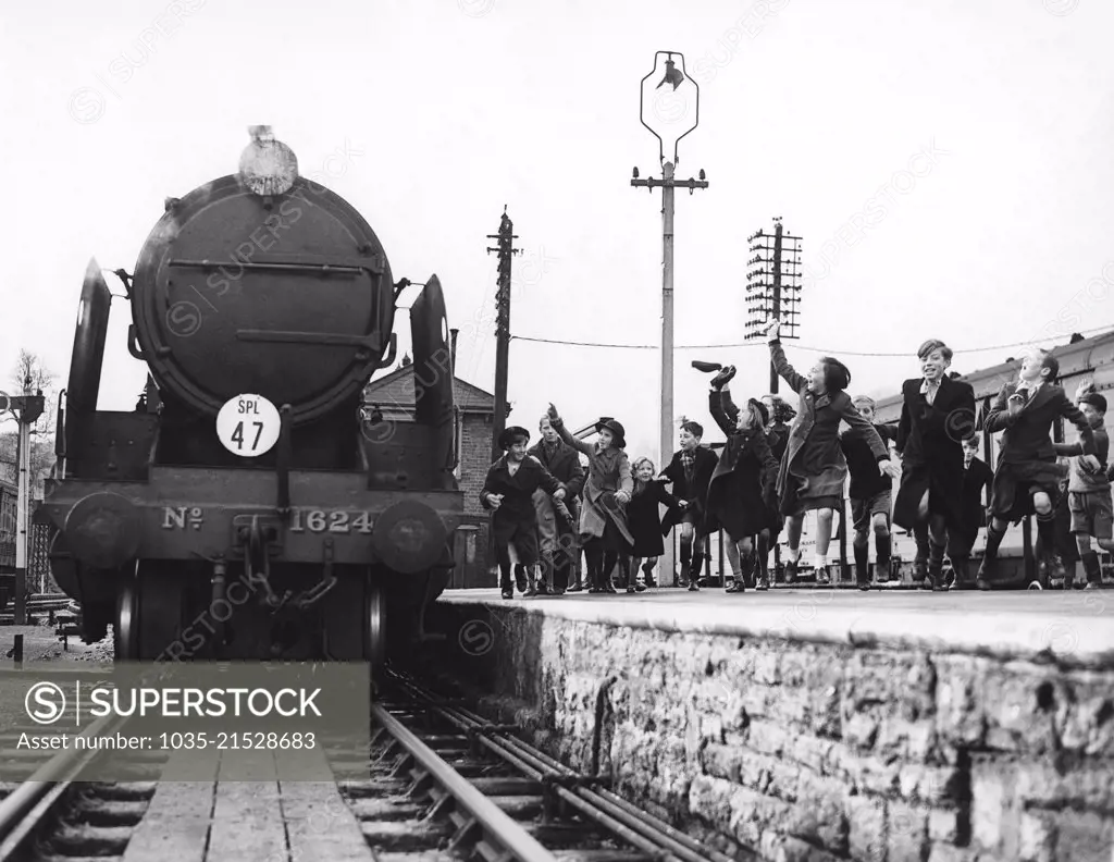 Yeovil, England:  December 3, 1939 Children who were evacuated from London during WWII excitedly greet the Southern Railway Evacuation Special train as it pullls in with their parents and relatives for a visit.
