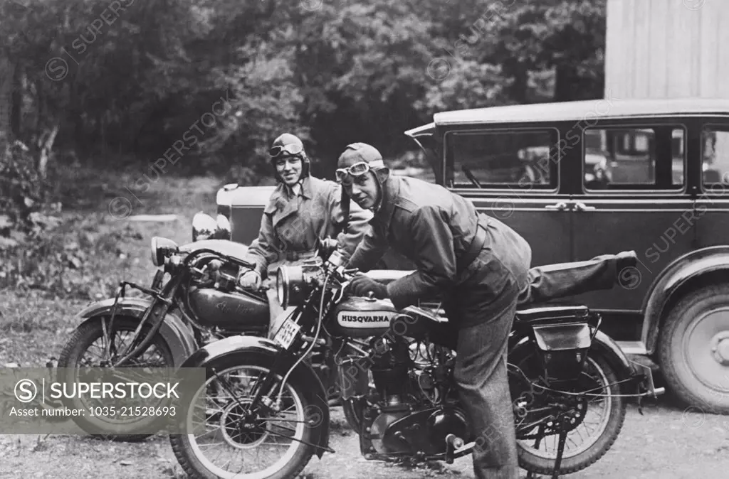 Sweden:  c. 1928 Prince Sigvard, right, the son of Swedish Crown Prince Gustavus Adolphus, returning from a spin in the country on his Swedish made Husqvarna motorcycle.