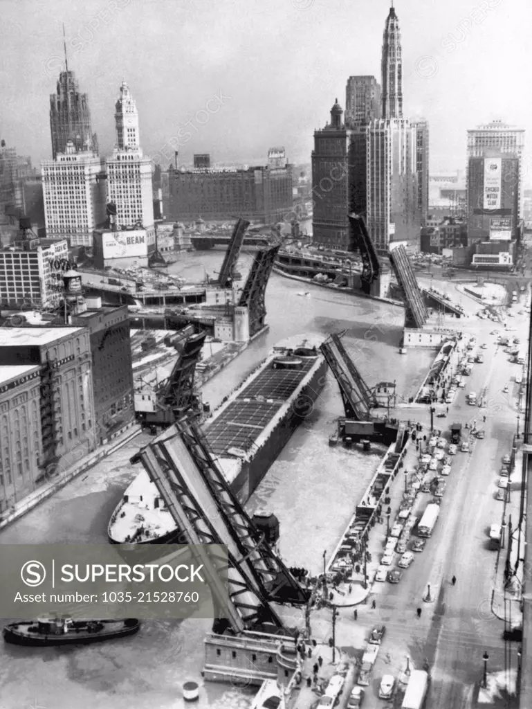 Chicago, Illinois:  September 3,  1953 The drawbridges are up for the arrival  of the former troop transport ship, "The Marine Angel". The ship was towed up the Mississippi River to Chicago and on to Lake Michigan where it was refurbished as a self unloading barge.