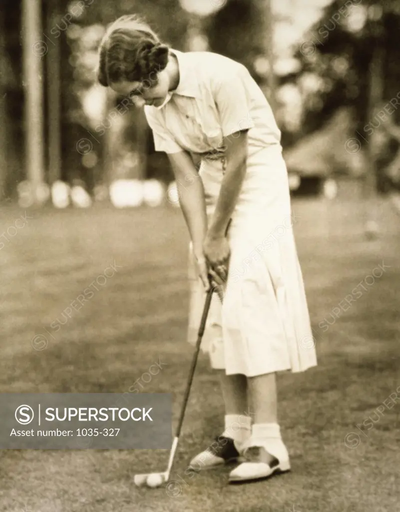 Side profile of a young woman playing golf