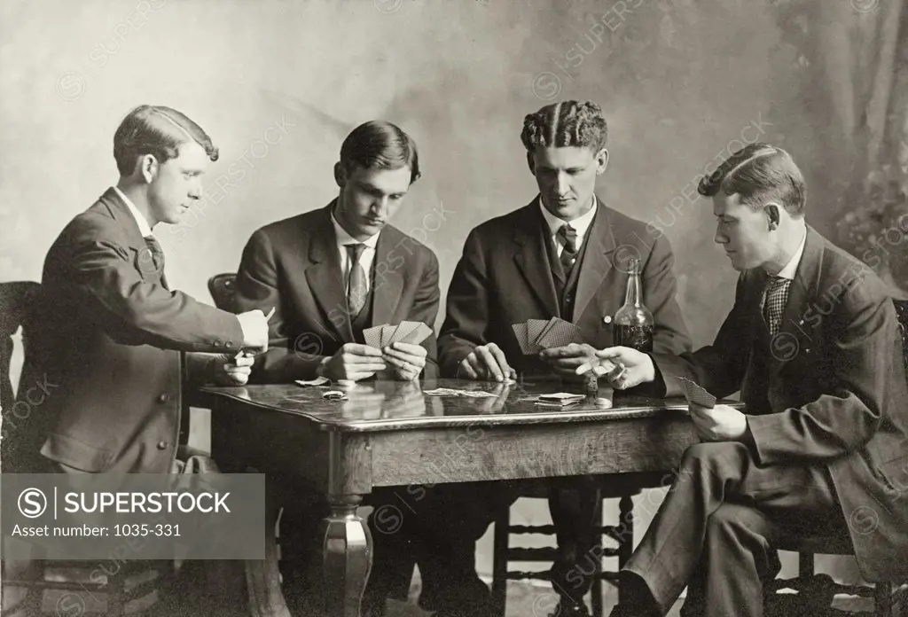 Four young men playing cards