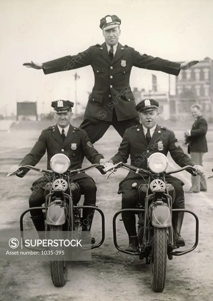 Policemen performing a stunt on motorcycles