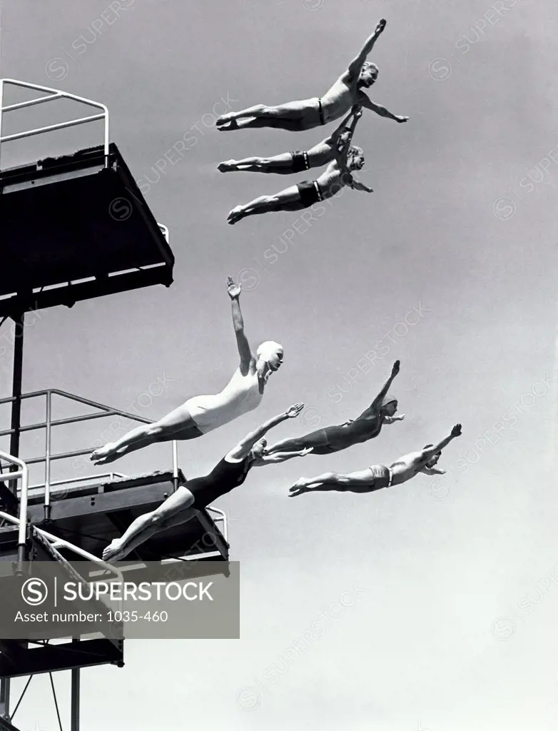 Low angle view of a group of people diving from diving boards