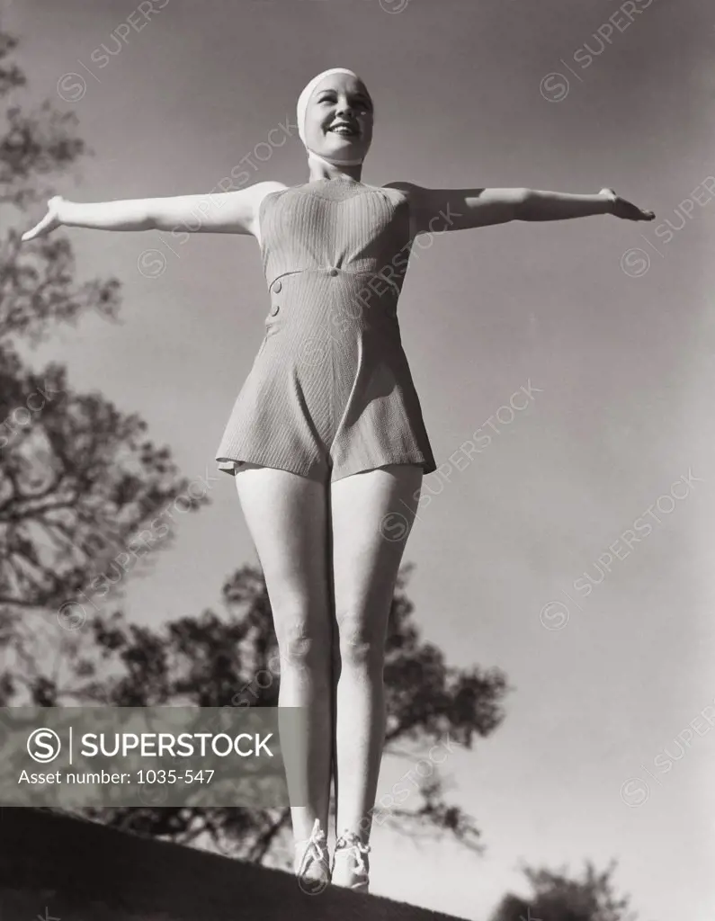 Low angle view of a young woman with her arms outstretched