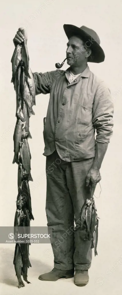 Mid adult man holding fish