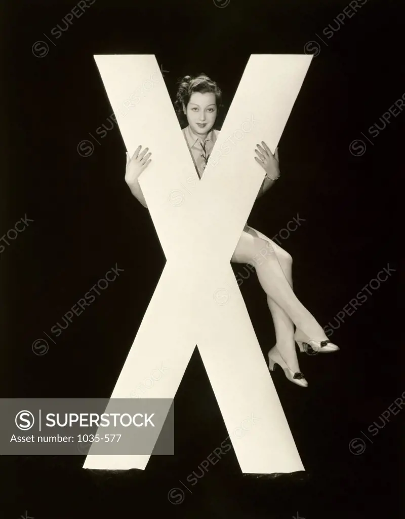 Portrait of a young woman posing with the letter X