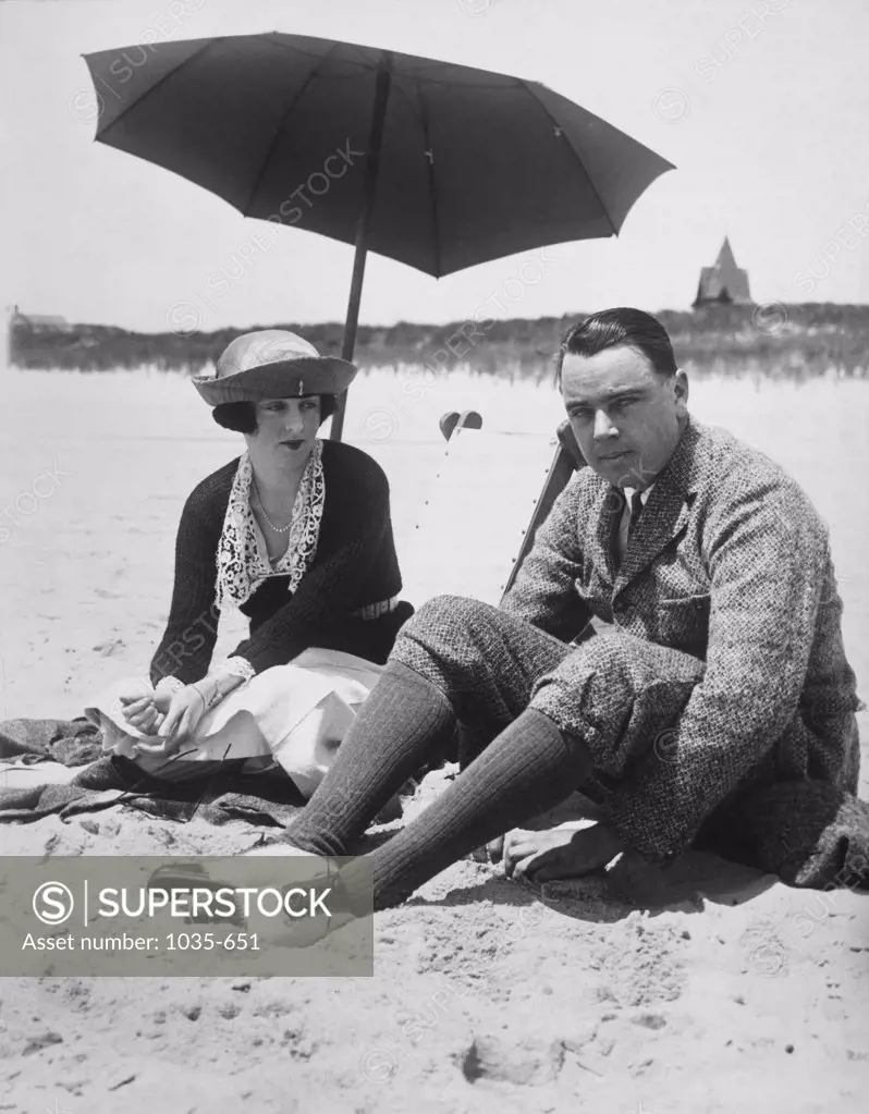 Mid adult couple sitting on a beach, Southampton, New York, USA, 1919