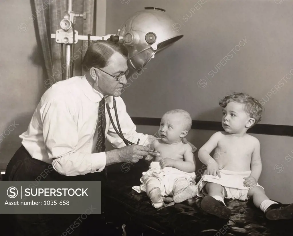 Doctor examining a baby, 1928