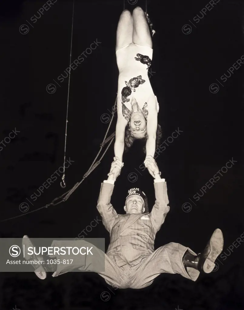 Male and female trapeze artist performing
