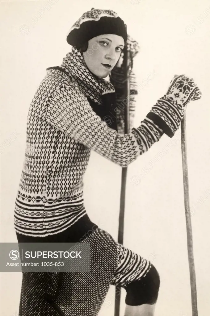 Portrait of a young woman holding a ski pole