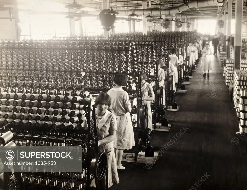 Group of women working on silk winding machines in a textile factory, Connecticut, USA