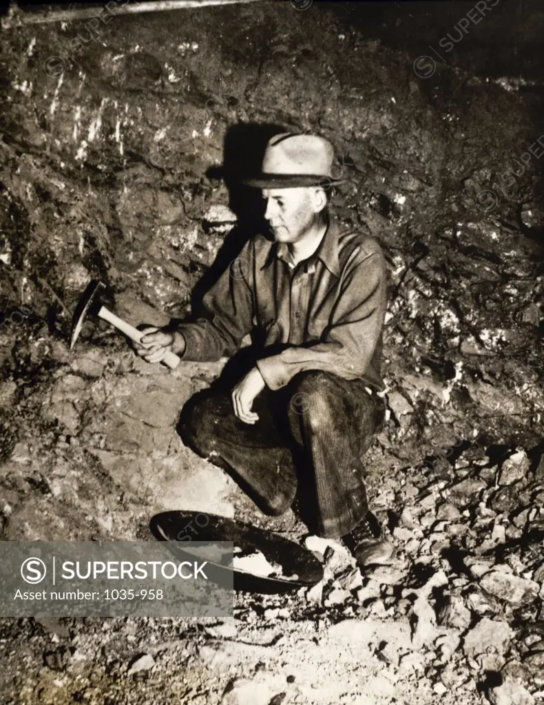 Mature man searching for gold in a gold mine, Cripple Creek, Colorado, USA