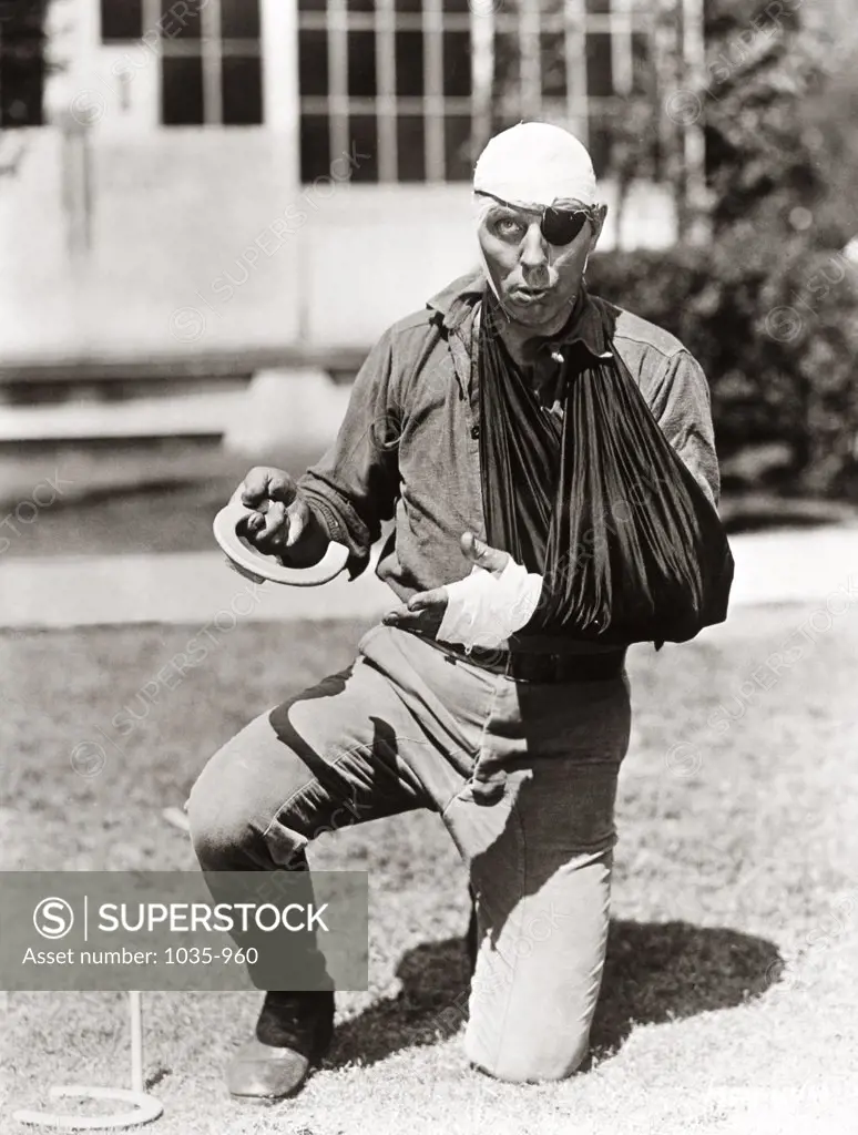 Portrait of a physically injured young man horseshoe pitching